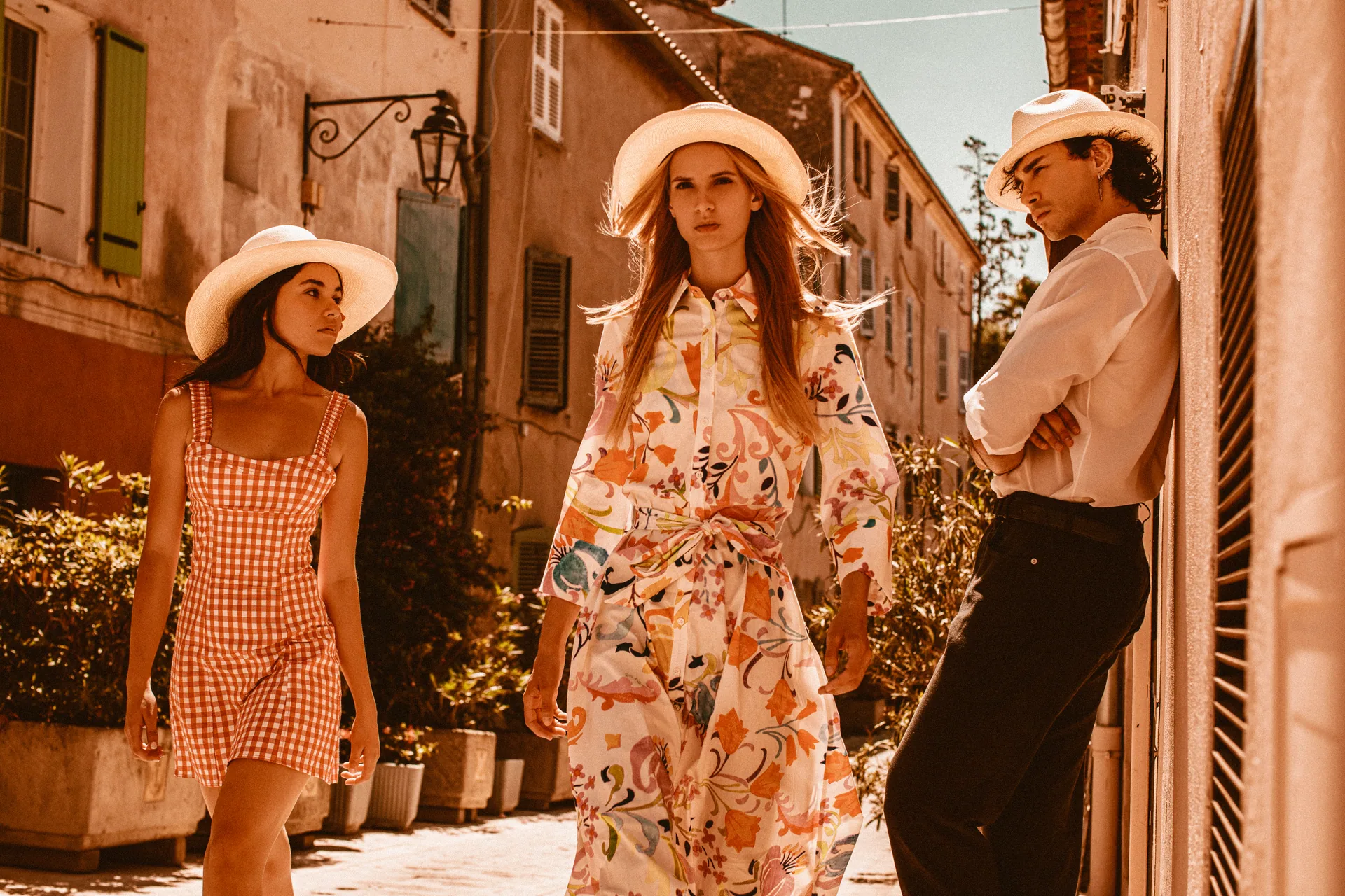 Three people wearing PanamaHatters hats on a summer journey