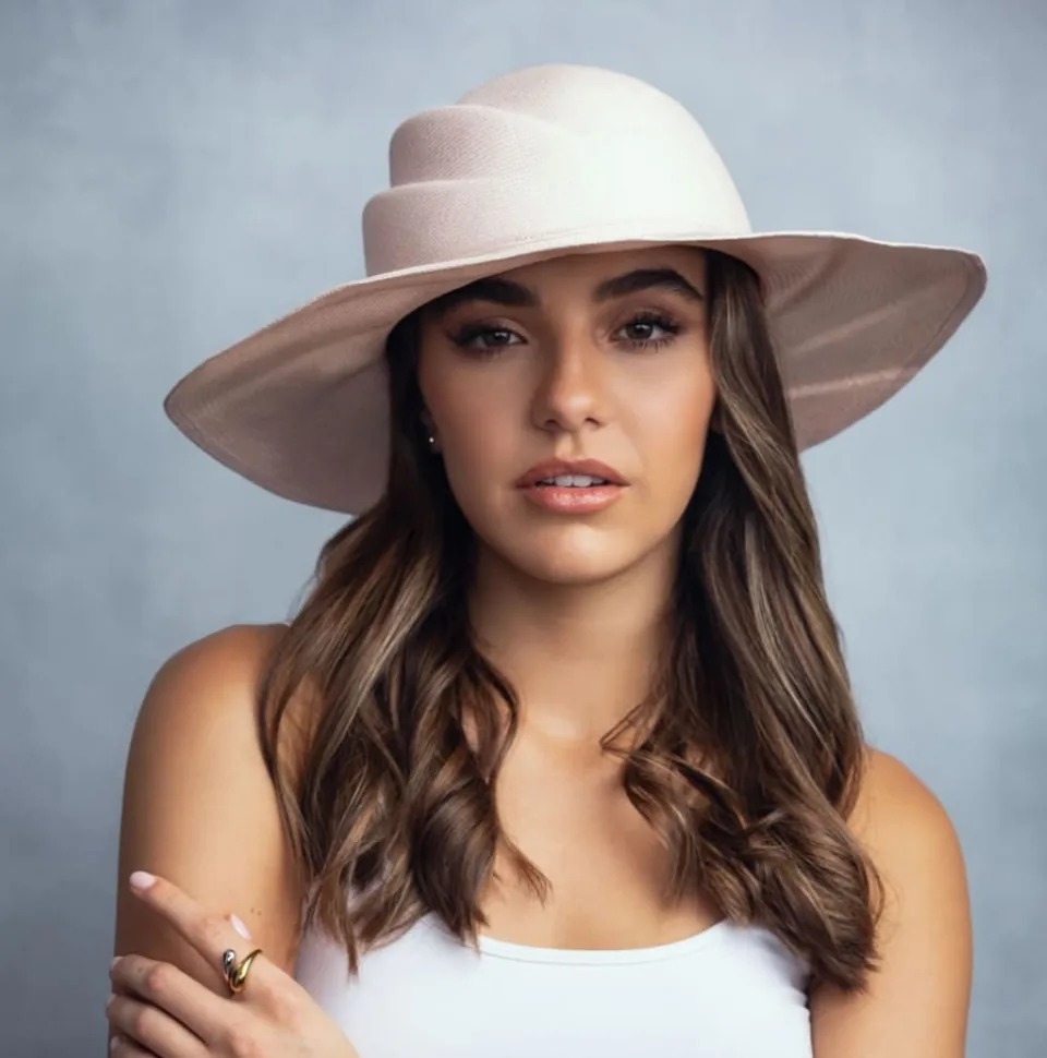 Woman in a blush wide-brim Panama hat