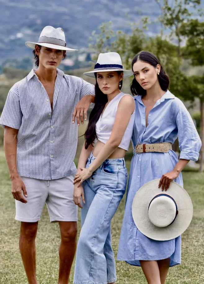 Three travellers in Panama Hatters hats in the countryside